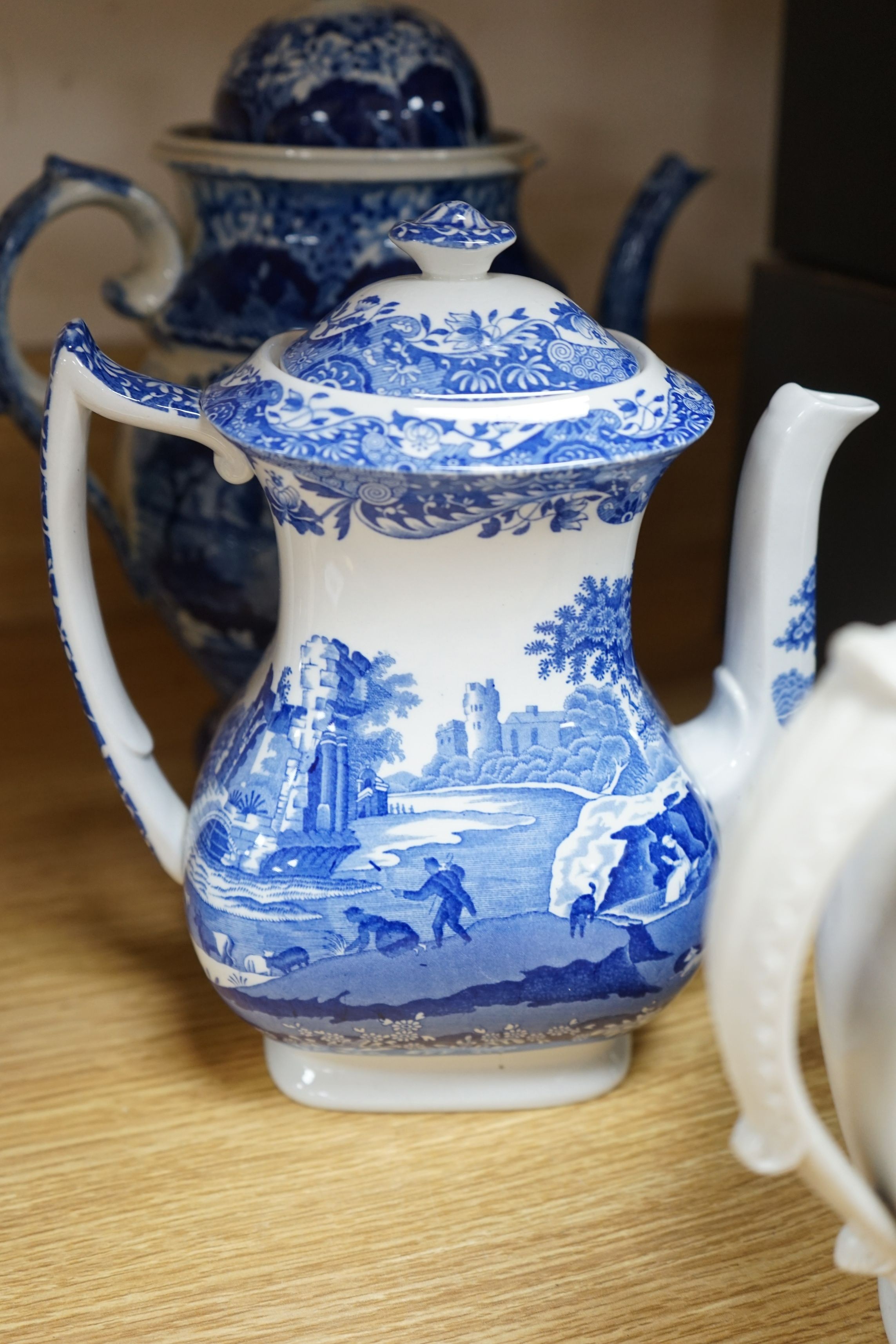 An early 19th century pearlware blue and white tea pot, two others and a Wedgwood style teapot, tallest 30cms high